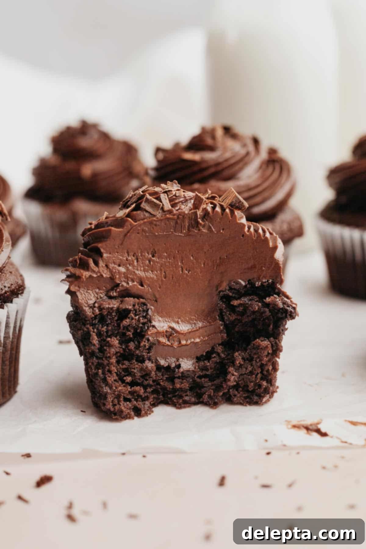 Decadent Chocolate Fudge Cupcakes 10 A chocolate cupcake sliced in half, showing a chocolate filling.