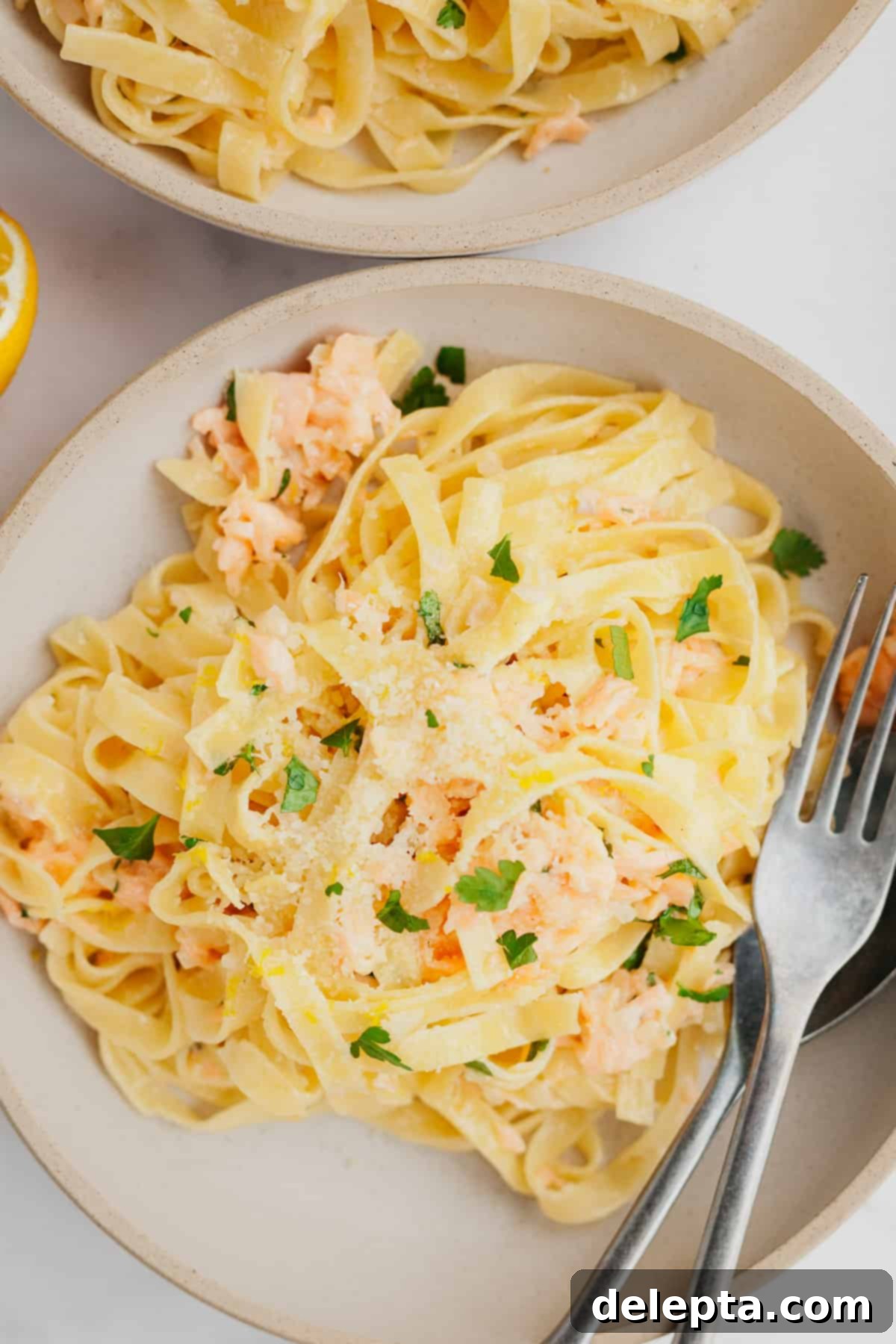 Creamy Salmon Pasta with Crème Fraîche 7 A vibrant bowlful of salmon pasta with creme fraiche, garnished with fresh herbs.