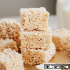 Fluffy Marshmallow Krispie Bars 8 A stack of three rice krispie treats.