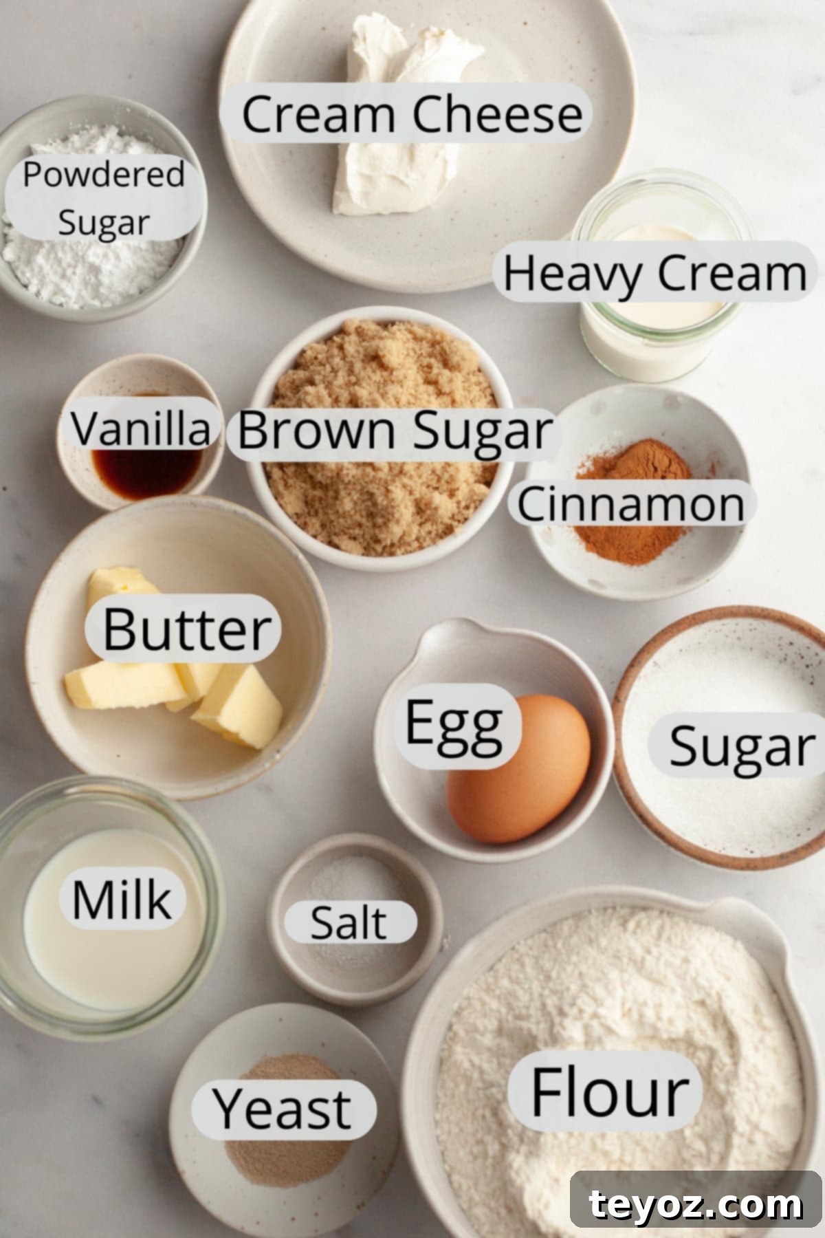 All the ingredients needed to make small batch cinnamon rolls, weighed out into small bowls, ready for baking.