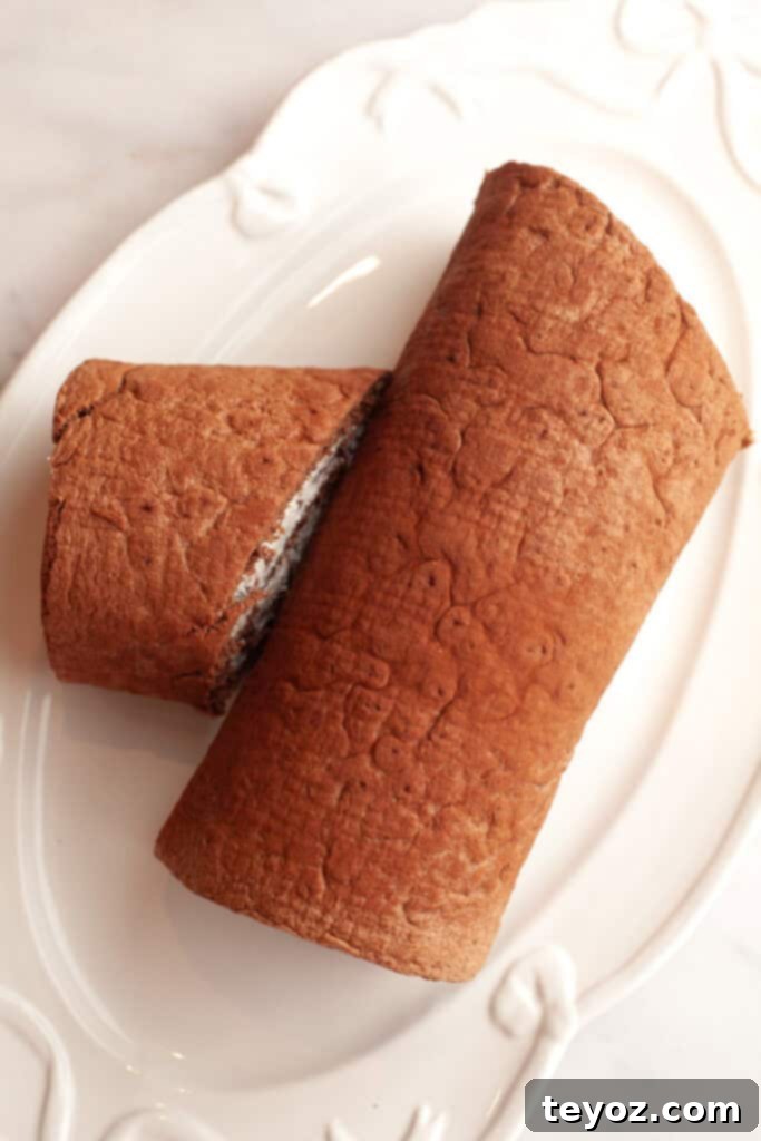 Aşağıdaki başlığı İngilizce'ye çevir ve özgünleştir: Black Forest Yule Log (Bûche de Nöel) Dark Chocolate Cherry Yule Log 12 A white serving platter with an unfrosted yule log, awaiting the ganache and decorations.