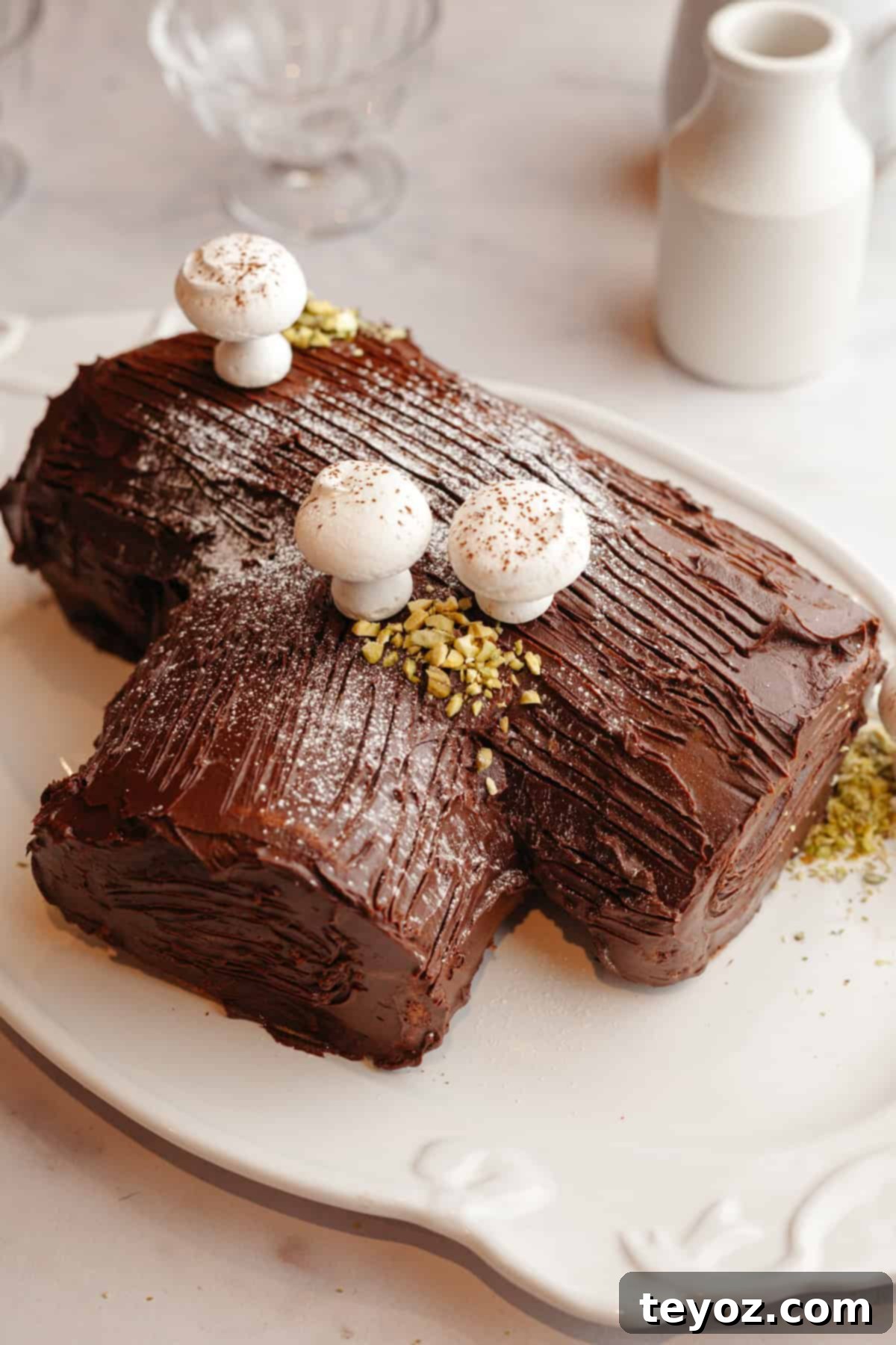 Aşağıdaki başlığı İngilizce'ye çevir ve özgünleştir: Black Forest Yule Log (Bûche de Nöel) Dark Chocolate Cherry Yule Log 13 A black forest bûche de noël on a white serving platter, covered in chocolate ganache and adorned with meringue mushrooms.