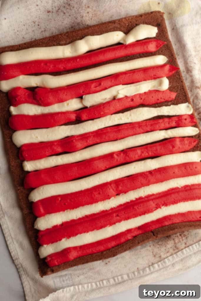 Chocolate Peppermint Dream Yule Log 12 A large rectangular chocolate cake adorned with red and white frosting piped in elegant candy cane stripes.