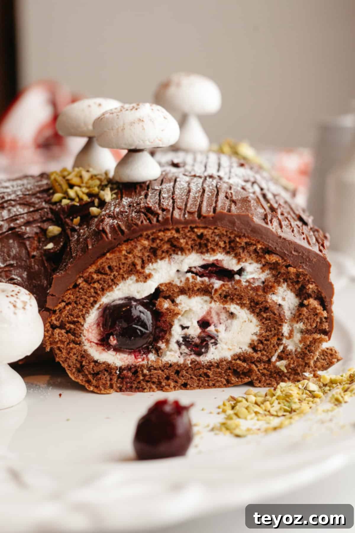 A chocolate yule log with cream filling topped with meringue mushrooms.