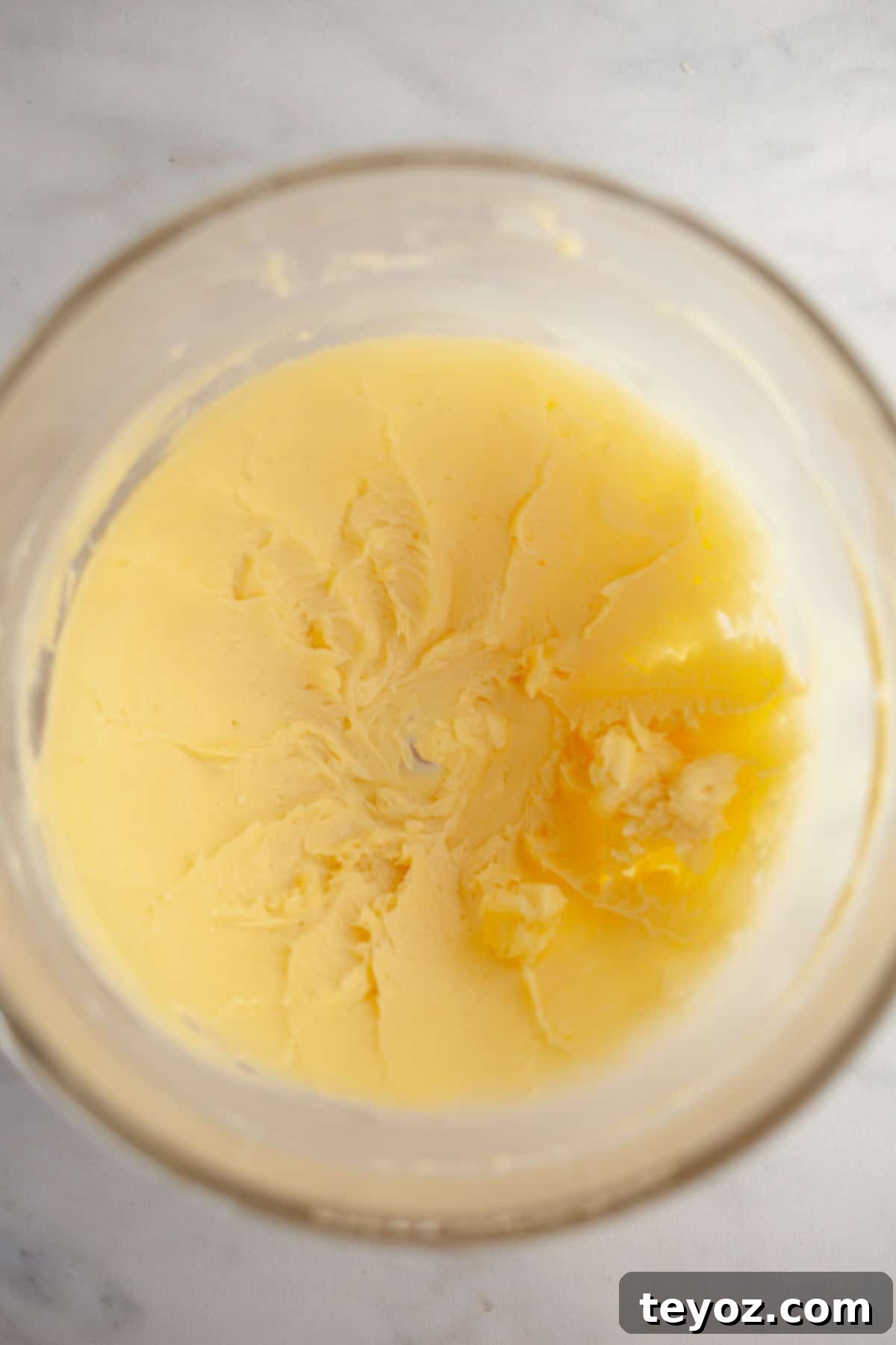 Double the Zing: Ginger Snap Delights 4 Creamed butter and sugar in a clear glass bowl.