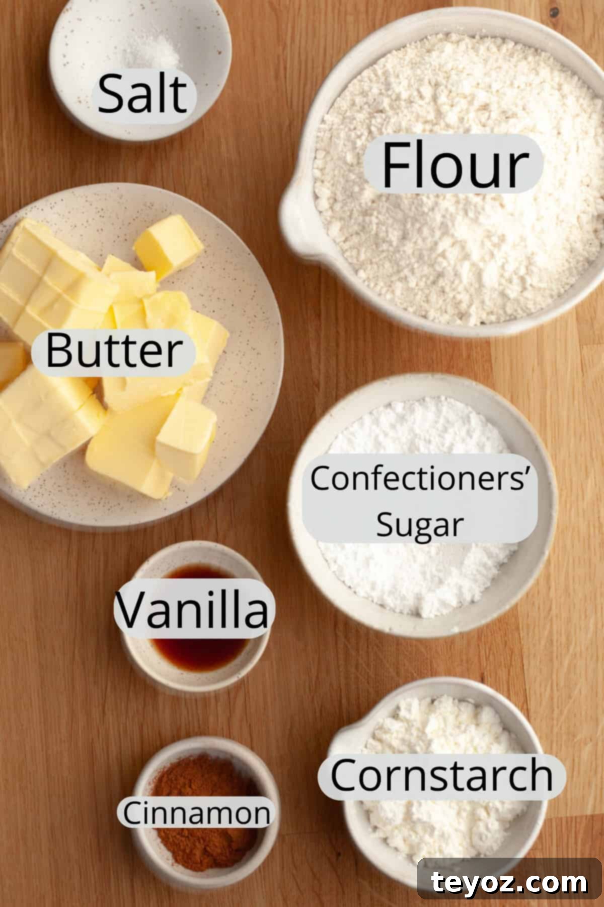 A captivating display of cinnamon shortbread cookie ingredients, neatly arranged in small bowls, ready to be transformed into a delicious treat.