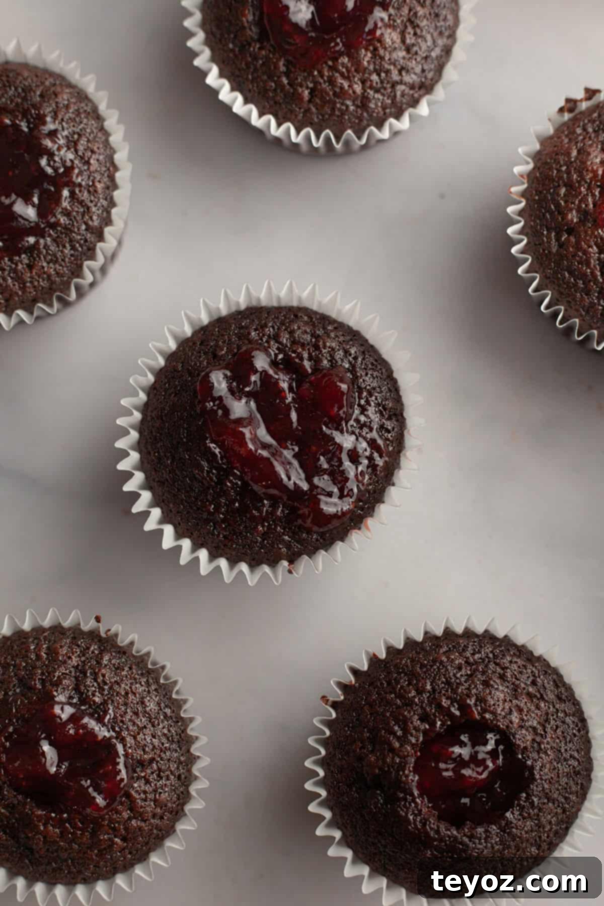 Chocolate cupcakes filled with strawberry jam